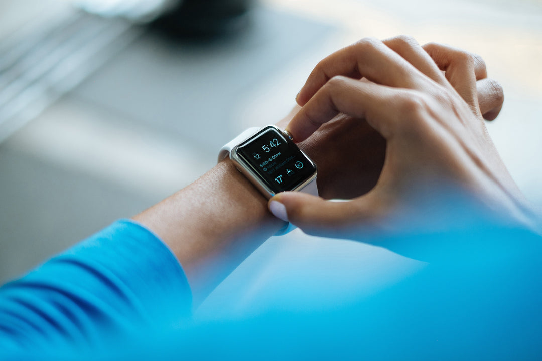 Athlete checking Apple Watch wearing a blue shirt